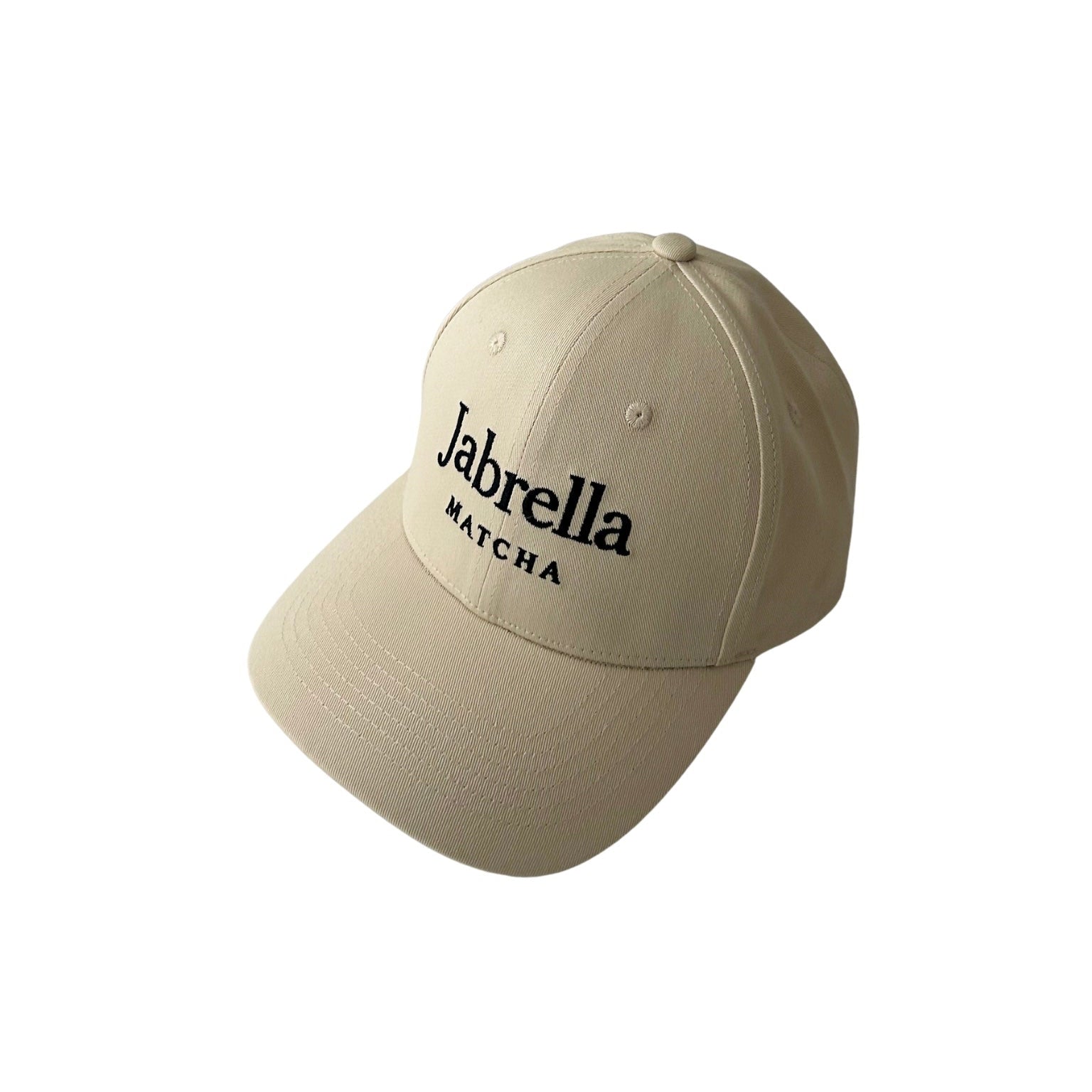 A beige baseball cap with 'Jabrella MATCHA' embroidered in black on the front, shown against a plain white background.